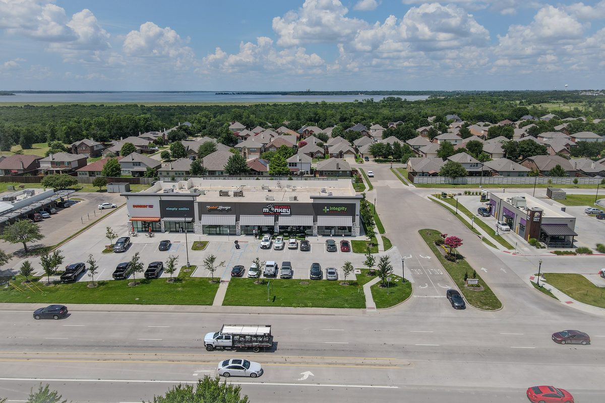 Lavon TX aerial — commercial district with Lake Lavon